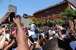 Crowds swarm LeBron James at the parade. - EMANUEL WALLACE / SCENE