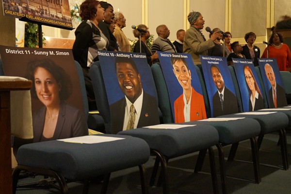 Pictures of County Councilpeople to mark their empty seats. (Both Yvonne Conwell and Jack Schron, along with the unpictured Dale Miler, eventually arrived). - Sam Allard / Scene