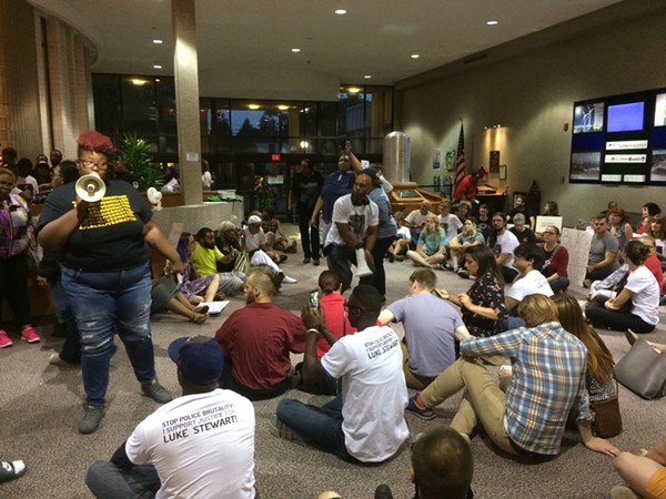 Rian Brown speaks to protesters in the lobby of the Euclid Municipal Building.