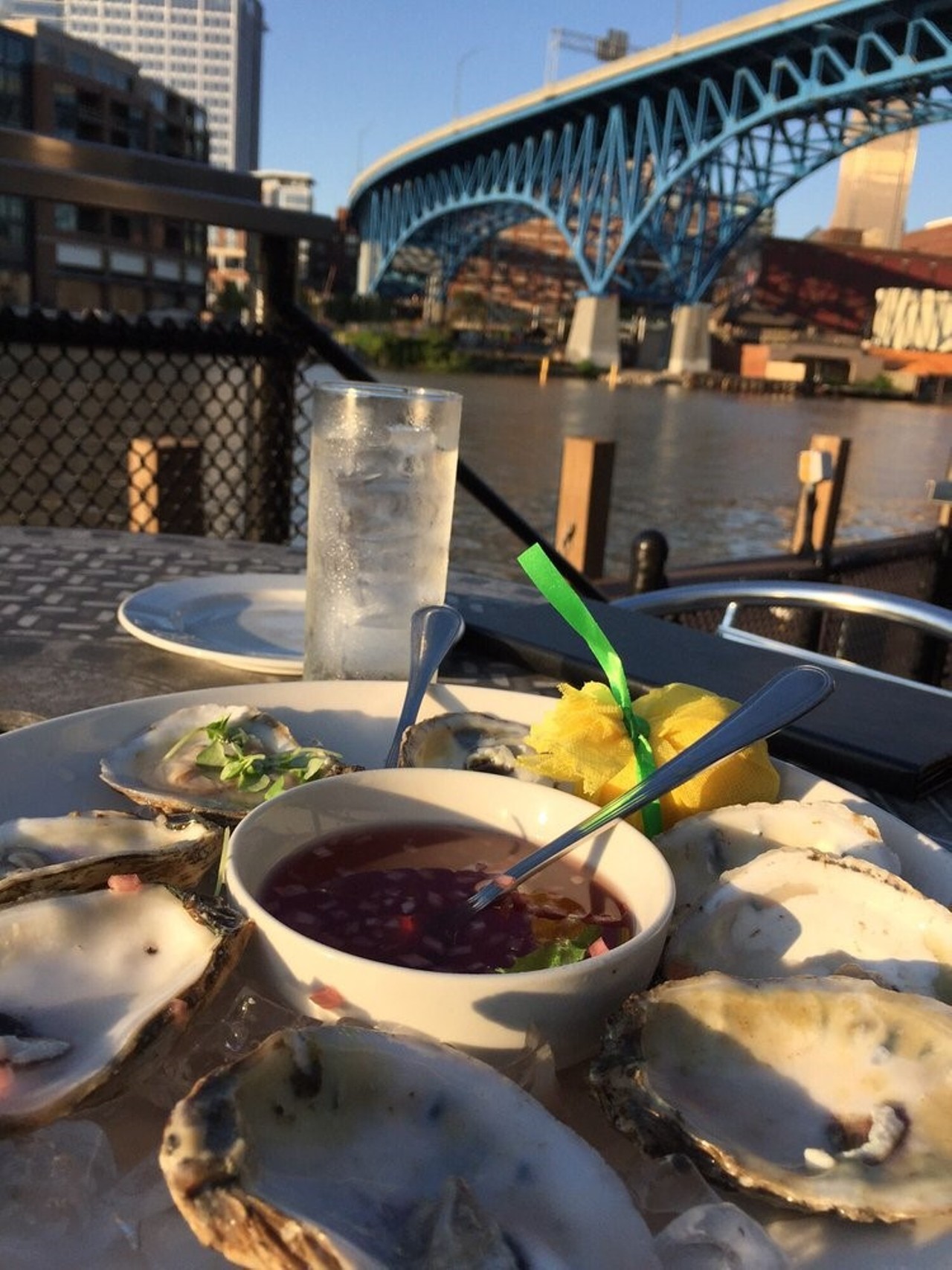 Rusty Anchor at the Music Box - 
1148 Main Ave. Cleveland - 
HH: 4-6:30 PM M-F
The title holder for both Most Mouthwatering Menu at the Downtown Cleveland Restaurant Week 2016 and OpenTable&#146;s Diners&#146; Choice 2016. Sitting perfectly amidst the water and the city&#146;s skyline, you feel like you&#146;re in the heart of Cleveland. If the food and the view&#146;s aren&#146;t enough, they have outdoor music events to soundtrack your experience. Although it is open only as a bar Monday and Tuesday, there&#146;s full restaurant service Wednesday through Sunday. If you haven&#146;t been yet this season, what&#146;re you waiting for?
http://rustyanchorcle.com/