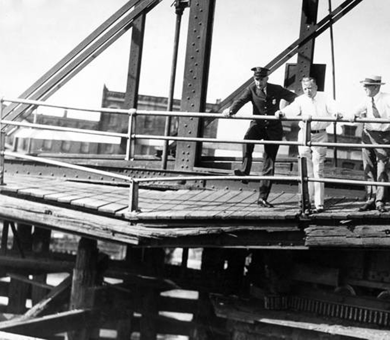 Men standing on the wooden deck, date unlisted.